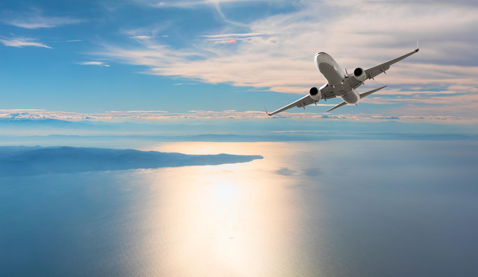 Private jet flying over the Mediterranean coast